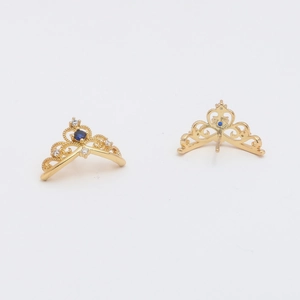 Detail of gold-plated crown pendant with blue stone and white cubic zirconia accents