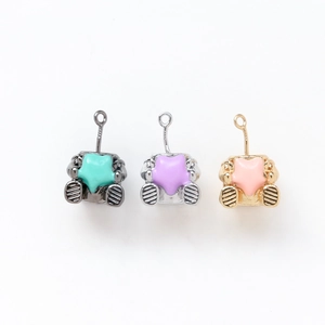 Detailed view of robot pendants with star enamel in gold, silver, and black metal