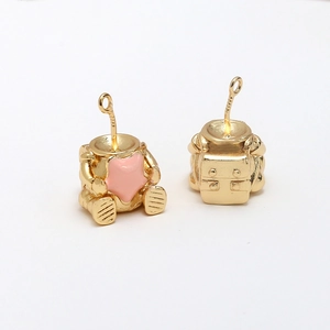 Detailed front and back of gold-plated astronaut charms with pink star enamel for DIY jewelry