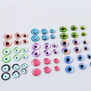 Detailed macro view of assorted glass evil eye cabochons in various sizes and vibrant colors