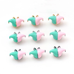 Macro shot of 9-piece pink and green jester hat charms with gold and silver plating