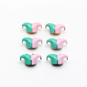 Macro detail of two-tone jester hat jewelry accessories in pink and mint green enamel