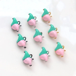 Macro detail of pink and green enamel clown hat charms for DIY jewelry making