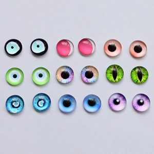 Flat lay of diverse glass evil eye cabochons for DIY jewelry and doll making crafts