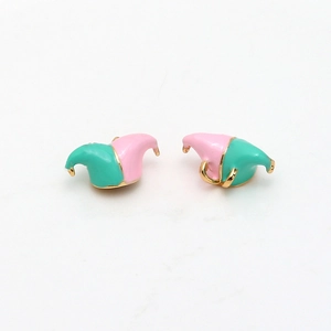 Macro shot of pink and green enamel jester hat jewelry findings with gold plating