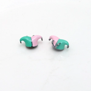 Macro detail of two-tone pink and mint enamel jester hat pendants for DIY jewelry