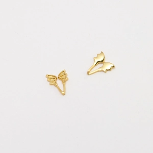 Detailed macro shot of 14k gold plated copper devil wing charms for DIY pearl jewelry