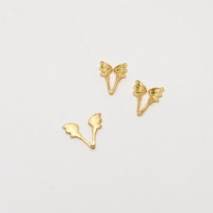 Macro shot of gold-plated angel devil wing charms for baroque pearl jewelry DIY