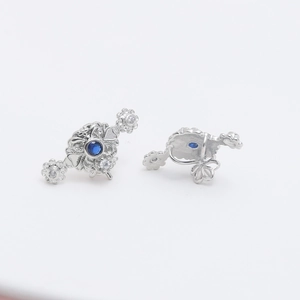 Baroque silver earrings featuring blue zircon center and white floral crystals