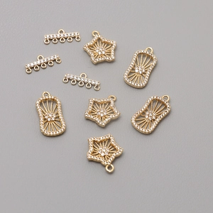 Macro shot of 18K gold plated star pendants with zircon inlay for DIY jewelry crafting