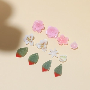 Macro detail of DIY resin flower and leaf charms for handmade hairpins and jewelry making