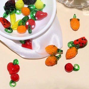 Macro shot of assorted glass fruit and vegetable charms for DIY jewelry making