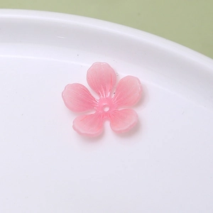Macro detail of pink translucent cherry blossom DIY bead with delicate petal textures