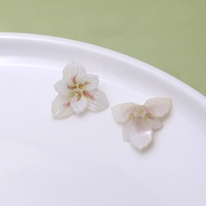 Macro detail of orchid resin charm with pink petal gradients for DIY jewelry making