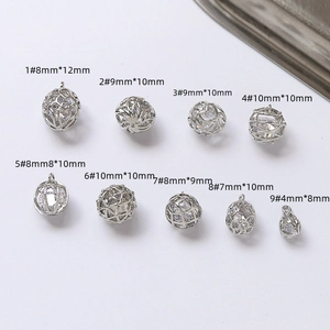 Macro detail of silver-plated copper pendants with zircon stones and hollow-out designs