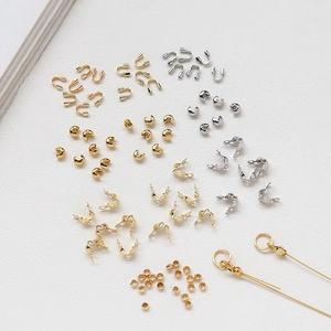 Detailed close-up of 14k/18k gold-plated U-shaped wire protectors and crimp bead covers