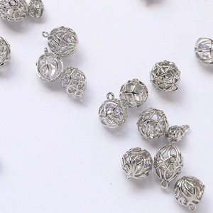 Macro detail of silver plated hollow cage pendants with inlaid sparkling zircon stones
