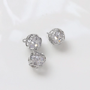 Close-up of DIY silver plated cage pendants with cubic zirconia for jewelry making