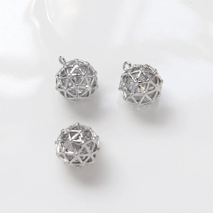 Detailed view of hollow silver spheres with embedded cubic zirconia for DIY jewelry making
