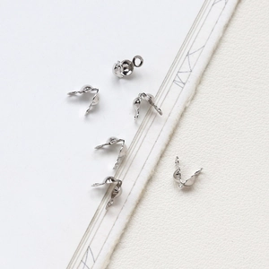 Macro detail of silver C-shaped bead covers for DIY jewelry necklace and bracelet making
