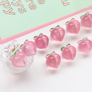 Detail shot of pink peach resin hair claw clips and beads with glossy gradient finish