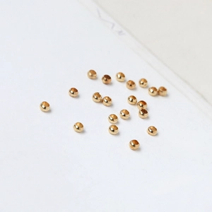 Macro shot of 18K gold-plated smooth positioning beads for DIY jewelry making accessories