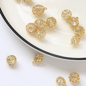 Detailed view of gold plated hollow sphere pendant with zircon stones for DIY jewelry