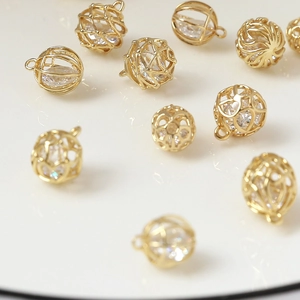 Golden hollow cage pendant with embedded sparkling cubic zirconia for DIY jewelry making