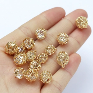 Macro shot of 18k gold plated hollow sphere charms with large zircon stones for DIY jewelry