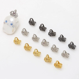 Detailed view of gold and silver crown charms with zircon inlay for baroque pearls