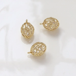 Detail of 14k gold plated oval hollow pendants with inlaid white zircon for DIY jewelry