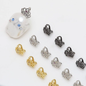 Detailed view of zircon crown pendant connectors on baroque pearls for DIY jewelry making