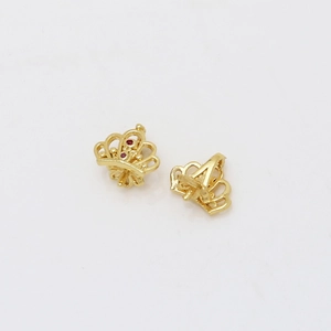 Macro detail of gold-plated crown pendant with zircon stones for DIY jewelry making