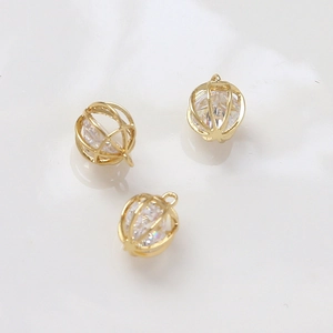 Detailed view of birdcage gold plated pendants featuring embedded cubic zirconia