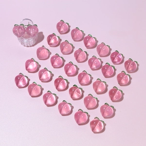 Detailed view of pink resin peach charms set for DIY jewelry and hair accessories