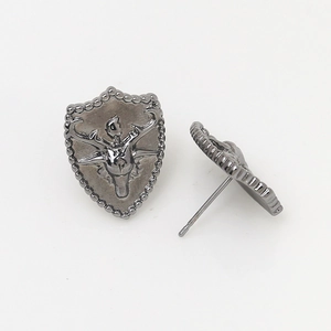 Detailed view of gunmetal deer head shield stud earrings with vintage embossed metal design