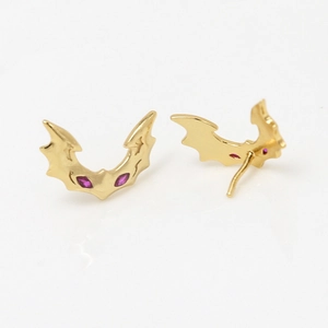 Gothic bat-shaped earrings in gold-plated brass with vibrant red gemstone eyes