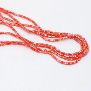 Macro shot of small orange square crystal beads with metallic luster for DIY jewelry making