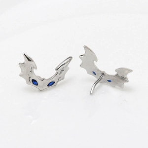 Detailed view of silver bat stud earrings with dark blue marquise zircon eyes