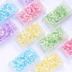 Detail of 2mm colorful glass tube beads in a transparent plastic organizer box for DIY
