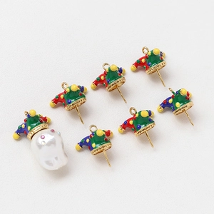 Macro detail of colorful enamel clown hat charms and baroque pearl for DIY jewelry making