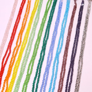 Close-up of 4mm faceted crystal rondelle beads in various rainbow colors for DIY jewelry