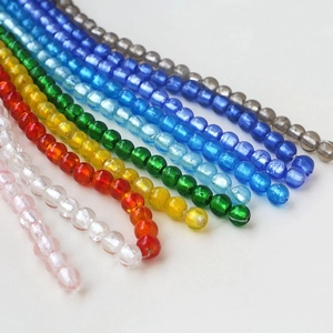 Close-up of assorted colorful glass beads in eight vibrant shades for jewelry making