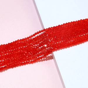 Macro shot of red faceted 4mm crystal bicone beads for DIY jewelry making and handmade crafts