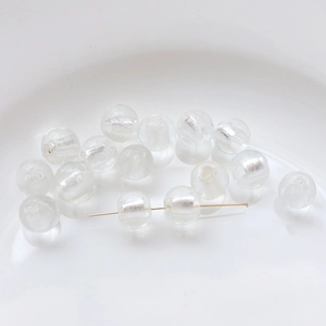 Macro shot of glass beads with silver gold-foil inserts for DIY jewelry making