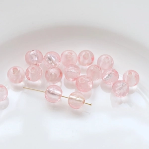 Macro detail of pink translucent glass beads with silver shimmer for DIY jewelry making