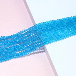 Close-up of light blue faceted crystal bicone beads for DIY jewelry making and crafts