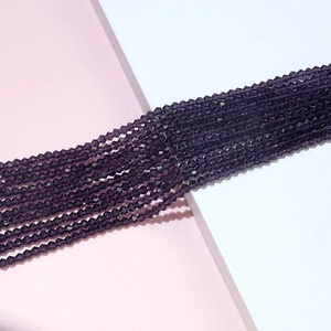 Macro view of 4mm faceted deep purple bicone crystal beads for DIY jewelry making
