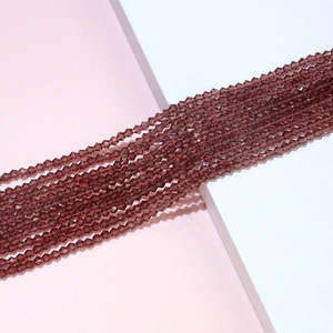 Macro shot of 4mm faceted mauve bicone crystal beads for DIY jewelry making