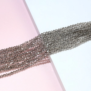 Macro shot of smoky grey bicone faceted crystal beads for DIY jewelry making and crafts